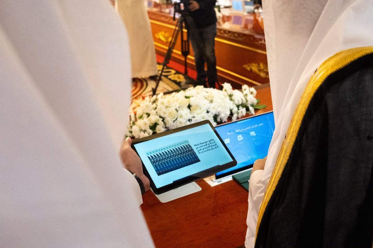 His Excellency Sheikh Dr. Mohammed Al-Issa, viewing a tablet “MWL Encyclopedia of Scientific Miracles in the Qur’an and Sunnah,” the first interactive digital scientific encyclopedia of its kind, available in ten languages